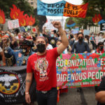 WASHINGTON, DC - OCTOBER 13: Demonstrators march to the White House during the third of five days of civil disobedience during the 'Climate Chaos Is Happening Now' protest on October 13, 2021 in Washington, DC. Organized by the Indigenous Environmental Network, the Sunrise Movement and other groups, activists marched to the White House to demand that U.S. President Joe Biden stop approving fossil fuel projects and declare a climate emergency ahead of the United Nations climate summit in November. (Photo by Chip Somodevilla/Getty Images)